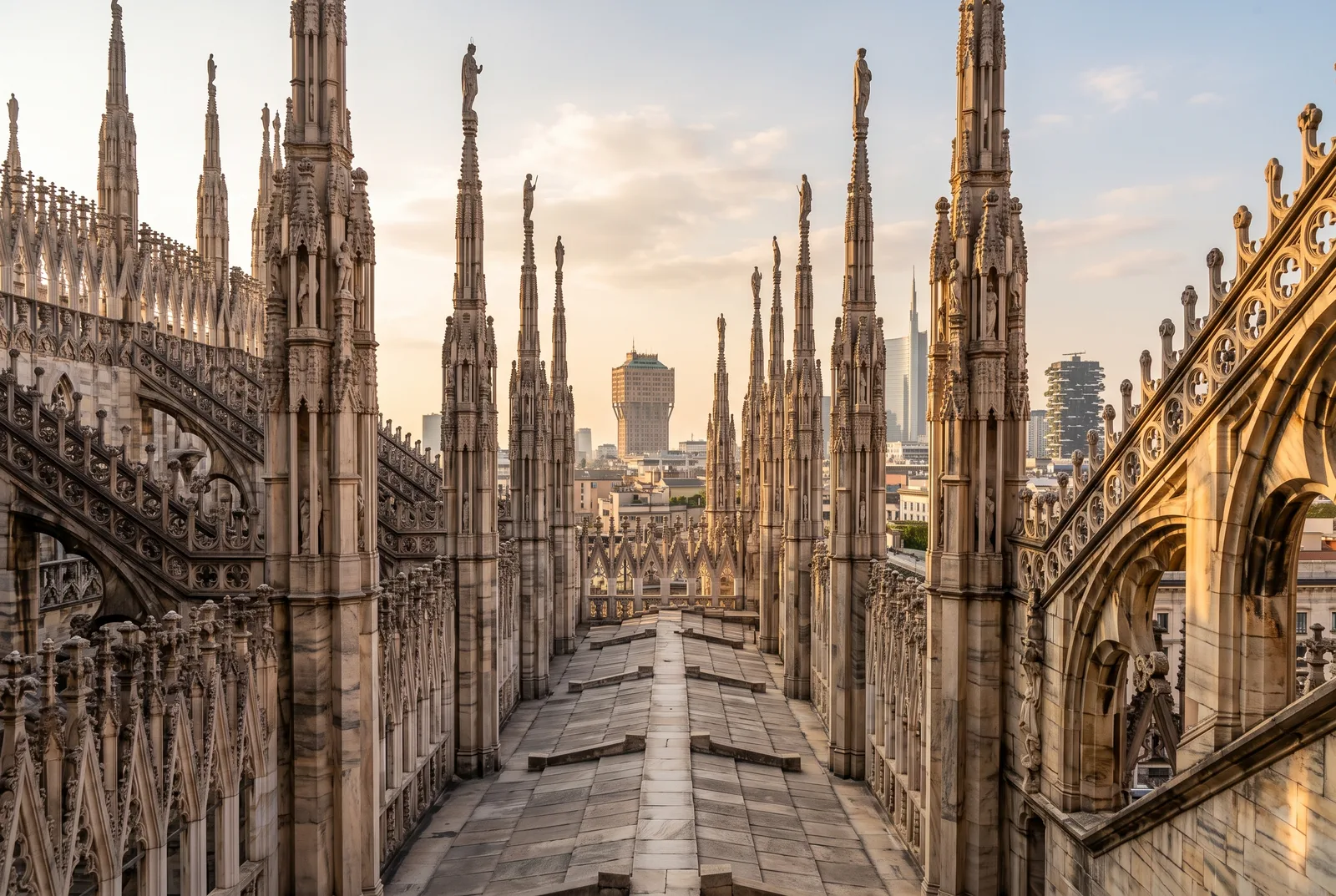 Marble walkway between carved spires and statues on the Duomo di Milano rooftop terraces